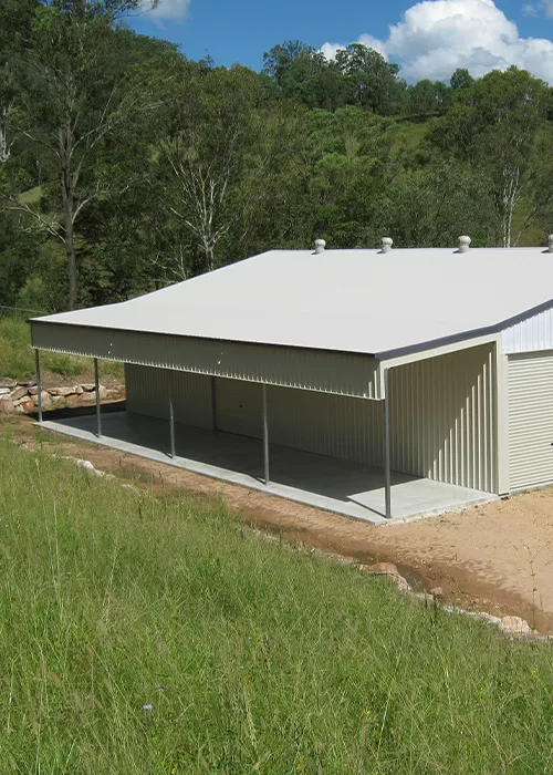 cream coloured shed with patio